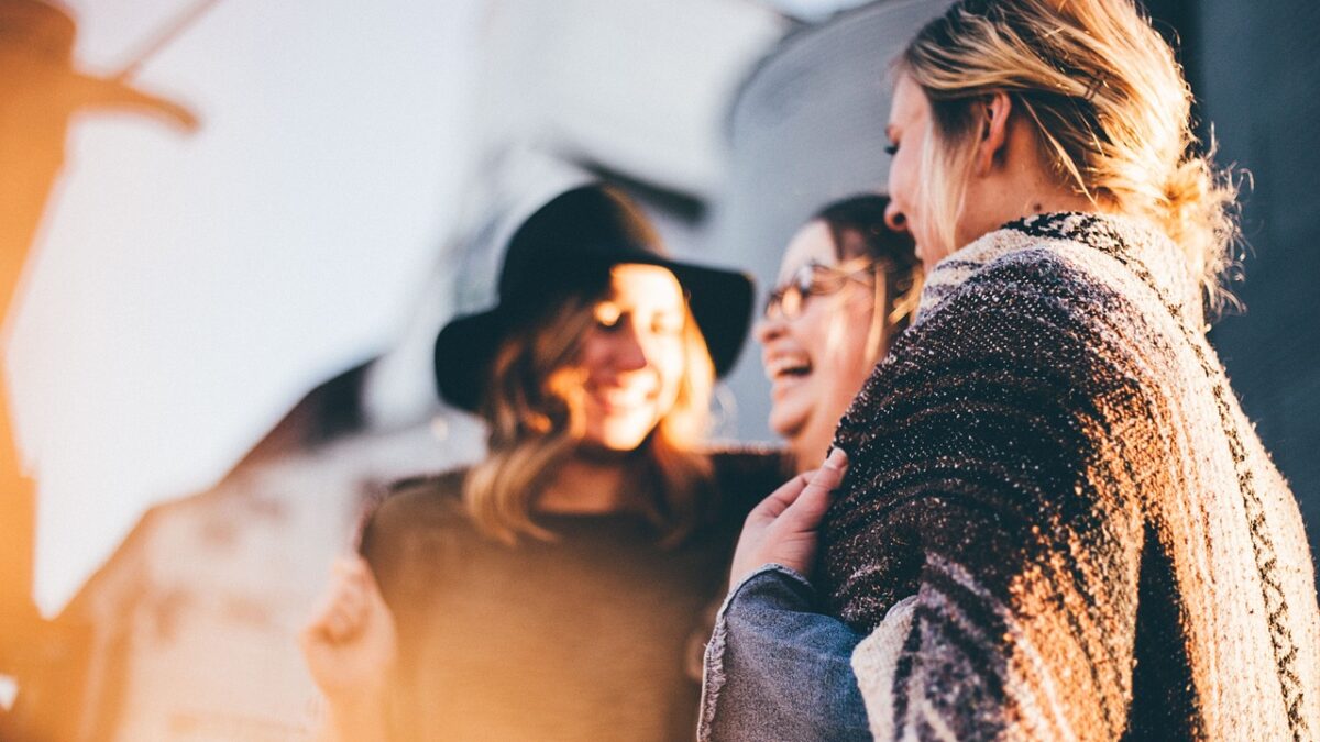 happy women standing and laughing together